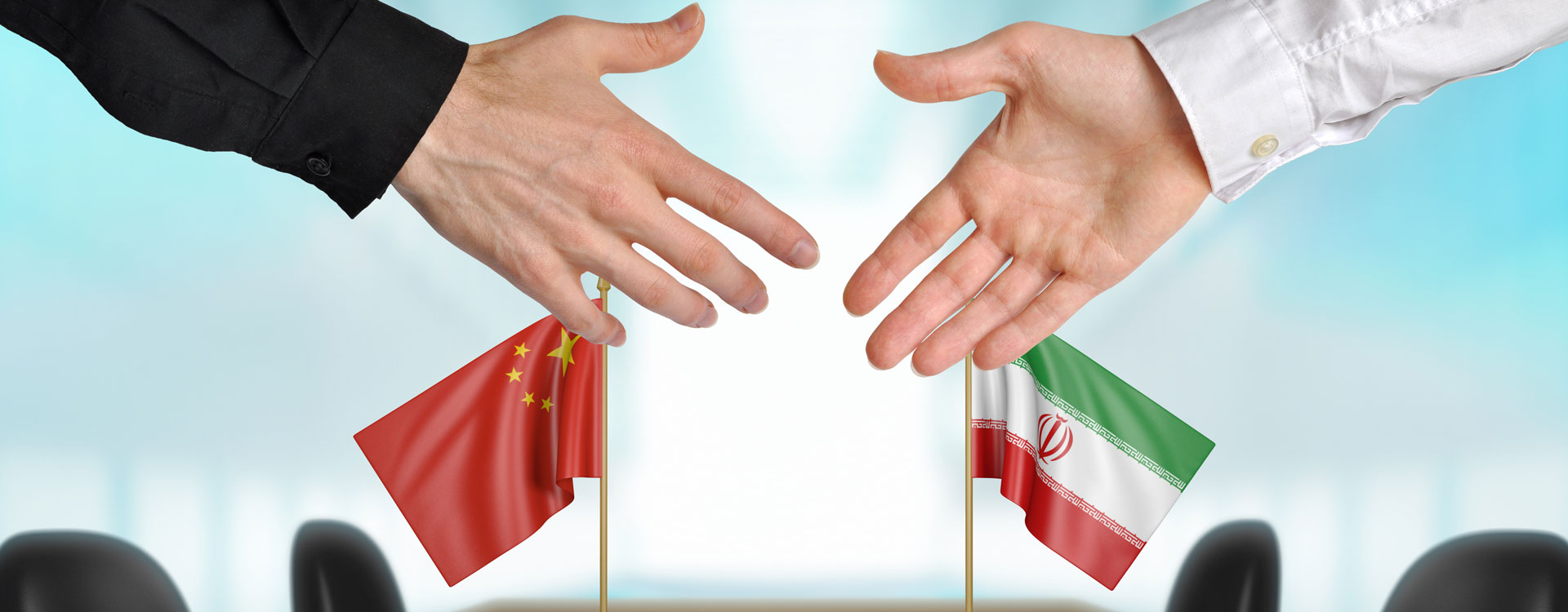 shaking hands and Iran and China flags