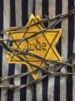 Yellow Star of David badge marked “Jude” pinned to a striped concentration camp uniform, with strands of barbed wire crossing the foreground.
