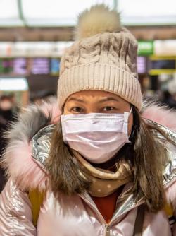 Girl at the airport wearing a mask