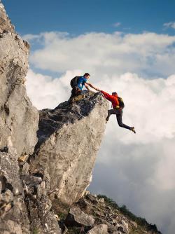 One climber helping another not to fall.