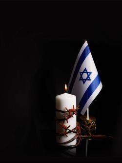 Candle with barbed wire and Israeli flag holocaust never again concept