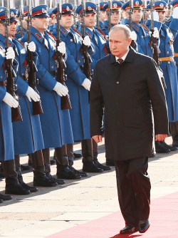 Putin walking in front of parade soldiers