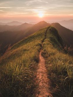 Narrow mountain trail at sunset