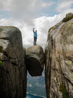 Man on precarious rock