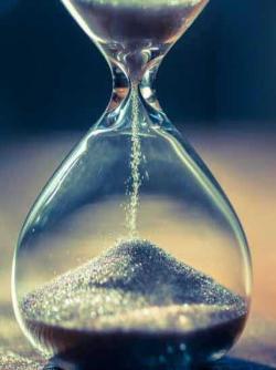 Sand moving through an hourglass
