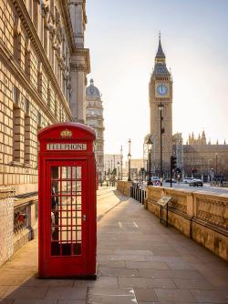 Red telephone booth near Big Ben in London