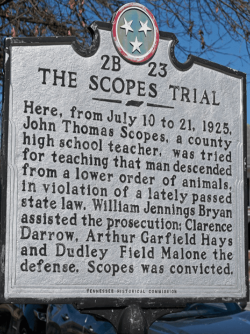 A Tennessee historical marker titled “THE SCOPES TRIAL” recounts the 1925 prosecution of teacher John Scopes for teaching evolution.