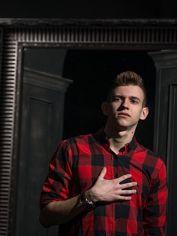 A young man talking to himself in front of a mirror