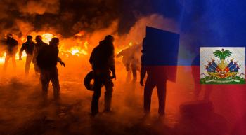 rioters with fire and a Haitian flag