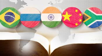 The flags of the BRICS countries above an open Bible