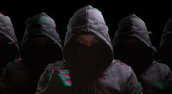 dark image of children wearing hooded sweatshirts