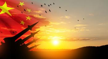 Chinese flag with missiles and sunrise with hills covered in trees or soldiers