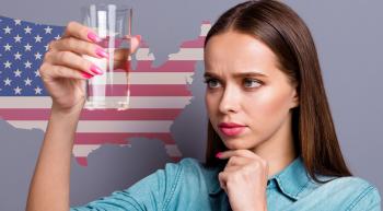 woman looking skeptically at a glass of water in front of a US map