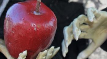 witch holding an apple