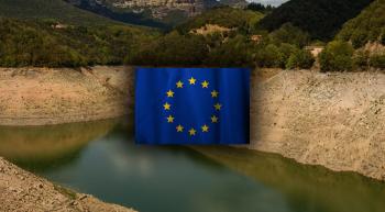 Almost empty Spanish reservior with EU flag in center