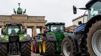 Parade of tractors approaching the Brandenburg Gate