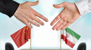 shaking hands and Iran and China flags