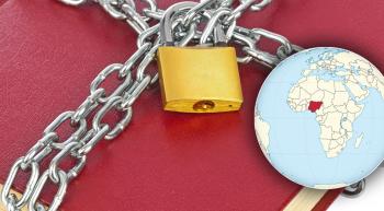 a Bible in chains next to a globe pointing out the country of Nigeria