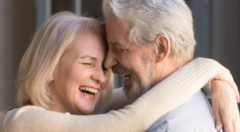 man and woman hugging and laughing