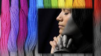 Woman praying, slowly turning from black and white into color, with stripes of vivid color in the background, fading from grey to rainbow shades.