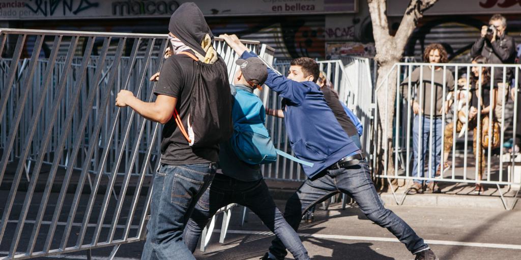 youth tearing down a barricade