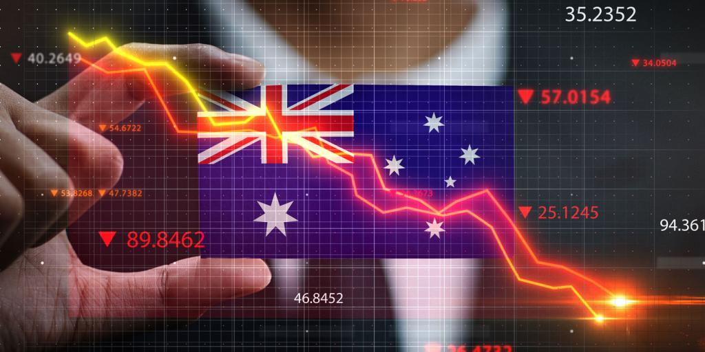 hand holding australian flag with downward trending arrows
