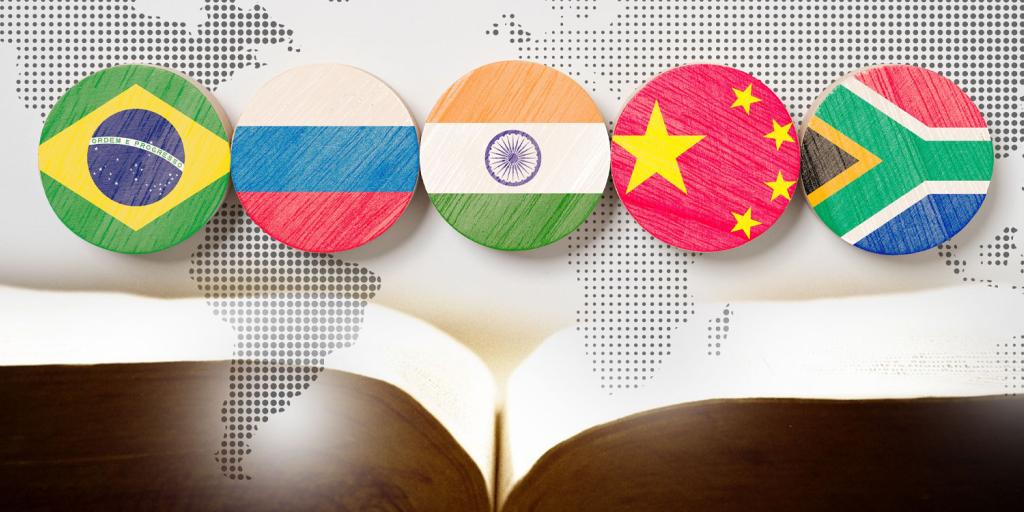 The flags of the BRICS countries above an open Bible