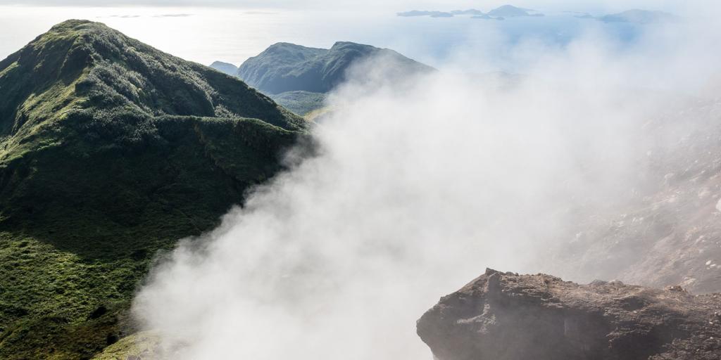 steam wafting from a tropical island mountaintop