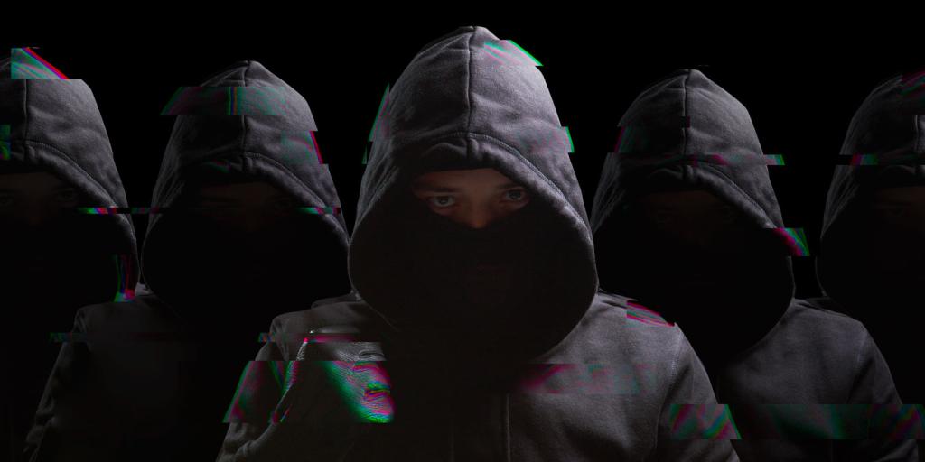 dark image of children wearing hooded sweatshirts
