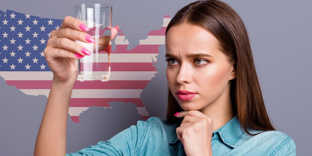 woman looking skeptically at a glass of water in front of a US map