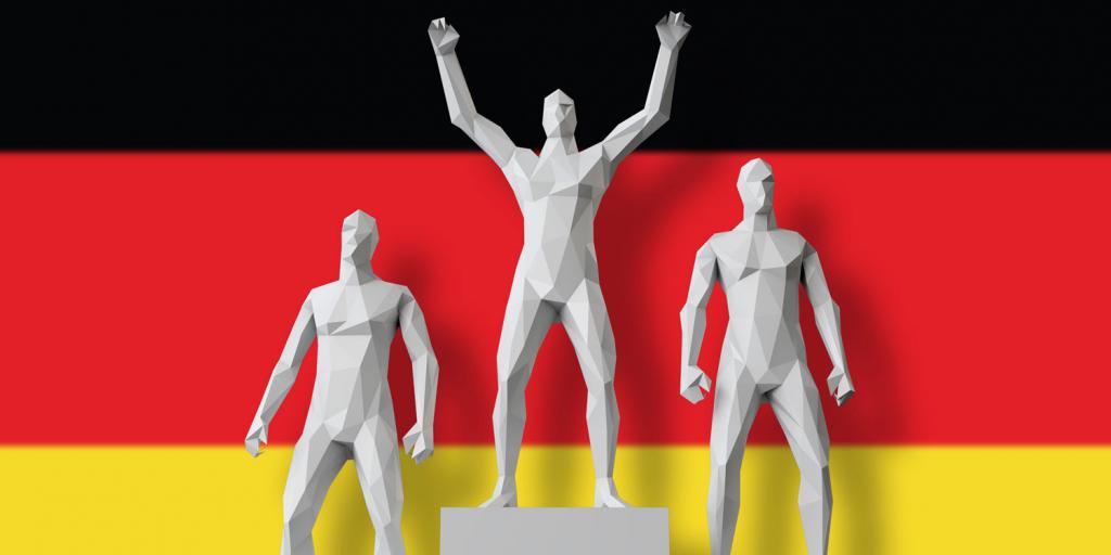 men on award podium in front of German flag