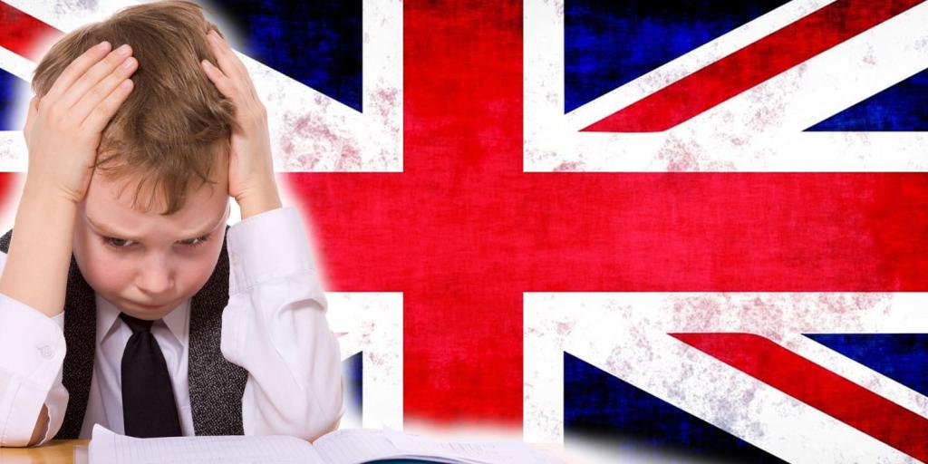 boy with his hands on his head in frustration with the British flag behind him