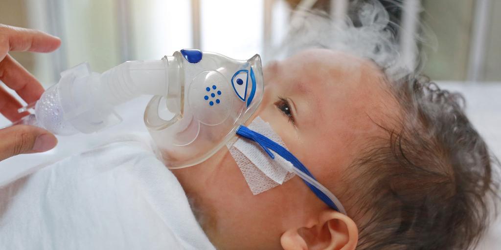 infant with an oxygen mask