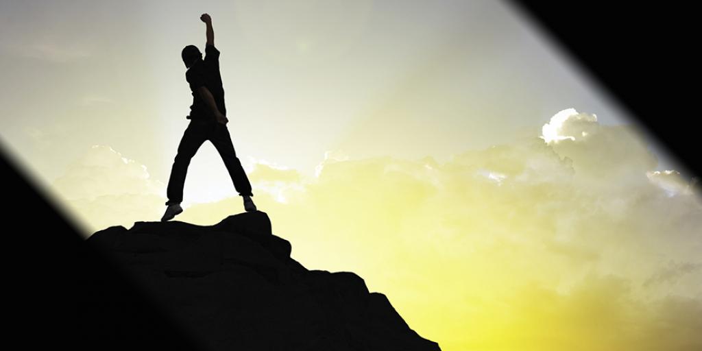 man standing on a mountain top