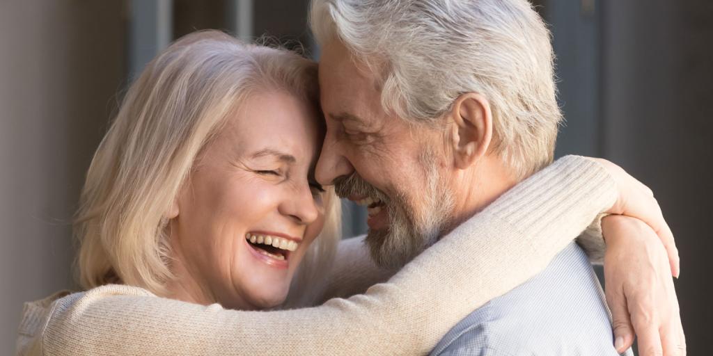 man and woman hugging and laughing