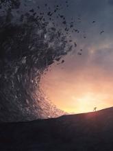 Crashing wave over a man running into the sunset