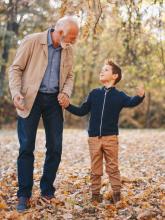 Grandfather and grandson walking outdoors