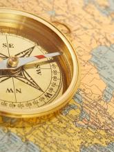 Antique compass on a New England map