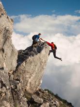 One climber helping another not to fall.