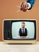 Man in a TV on puppet strings