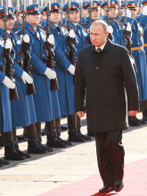 Putin walking in front of parade soldiers