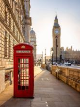 a London telephone booth with the Big Ben clock in the background