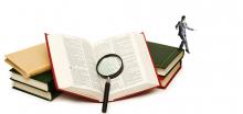A tiny blindfolded man walking off of a stack of books, one of which is an open Bible with a magnifying glass resting on it