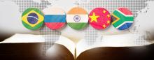 The flags of the BRICS countries above an open Bible