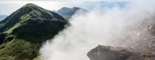 steam wafting from a tropical island mountaintop