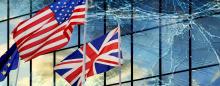 flags of US UK and EU with cracked windows behind them