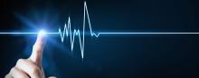 concept image of finger touching a cardiogram that is stopping signifying death