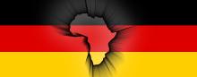 The shape of the African continent superimposed over the German flag