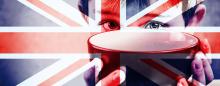 child holding up empty bowl with British flag