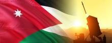 Jordanian flag next to a sillouette of a missile launcher